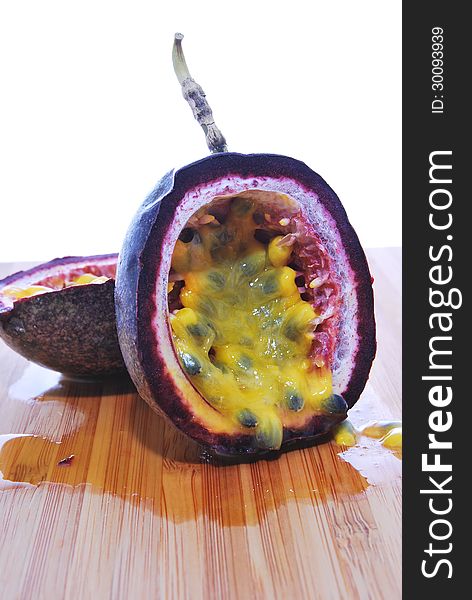 Cut passionfruit on a chopping board. Cut passionfruit on a chopping board