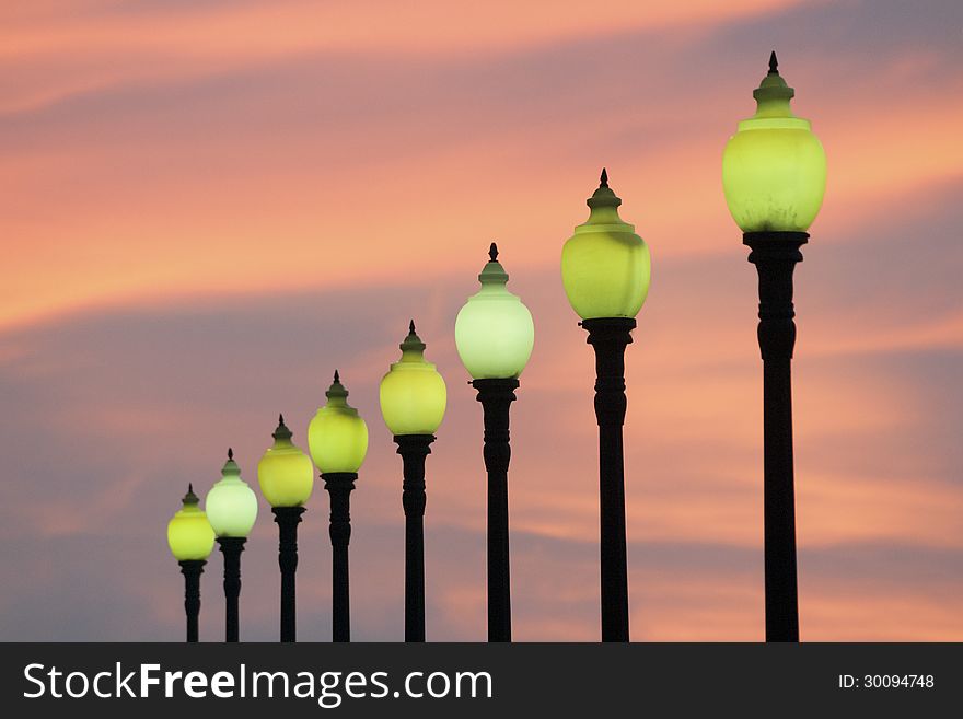 Row of classic style city lamps over twilight sky in Barcelona, Spain