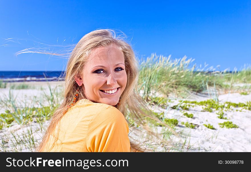 Young happy woman on a beach.