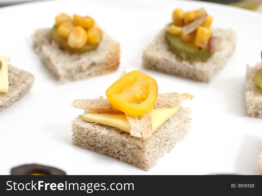 Fruit and vegetable canapes arranged as a face on a small plate. Fruit and vegetable canapes arranged as a face on a small plate