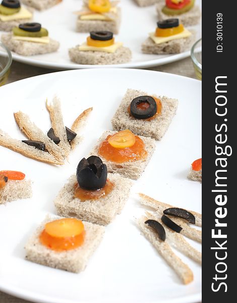 Fruit and vegetable canapes on a white ceramic plate. Fruit and vegetable canapes on a white ceramic plate