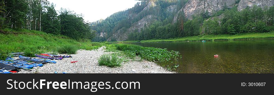 The river flows between mountains, ostium, forest, altitude, far, panorama. The river flows between mountains, ostium, forest, altitude, far, panorama