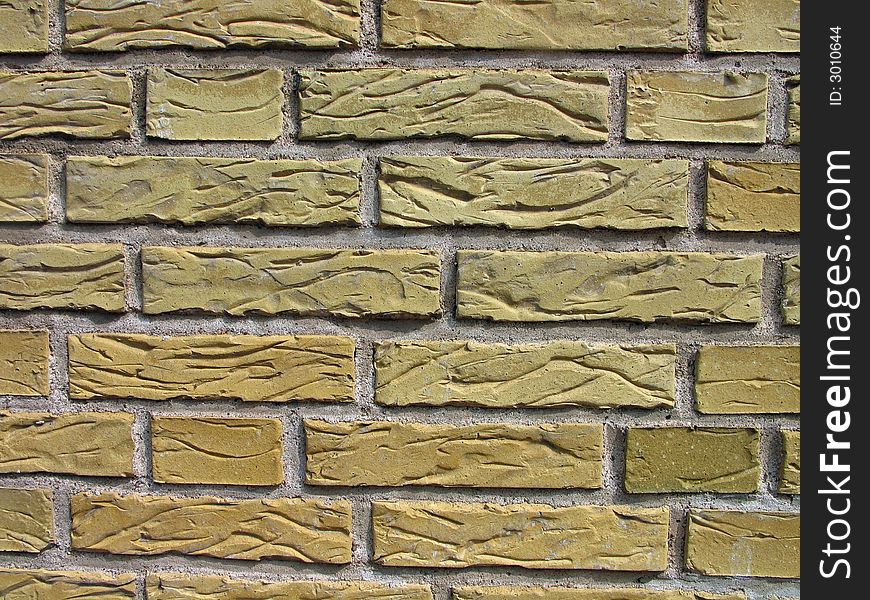 Details of a wall made with carved yellow bricks. Details of a wall made with carved yellow bricks