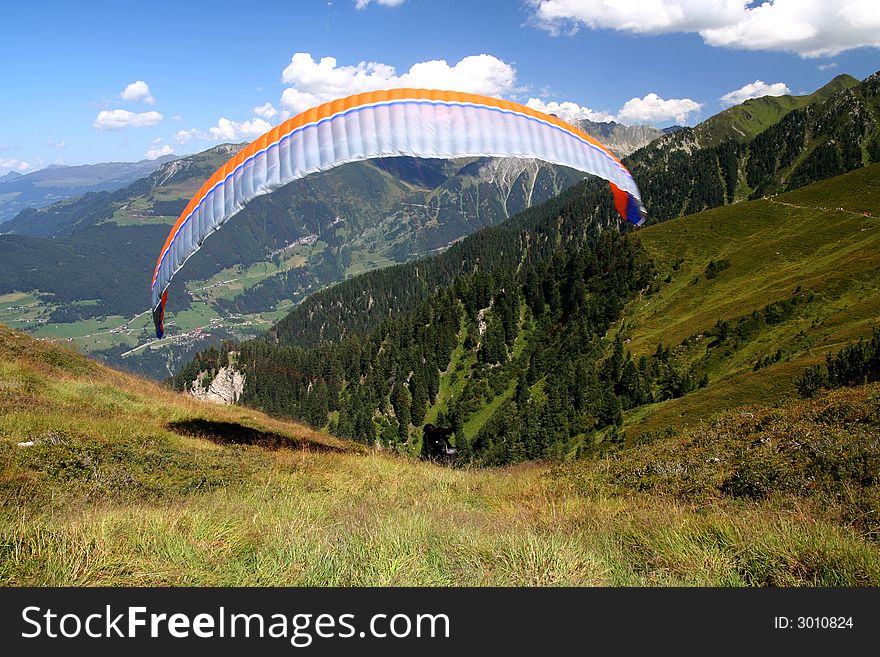 Image of a paraglider starting from mountain in Austrian Tirol. Image of a paraglider starting from mountain in Austrian Tirol