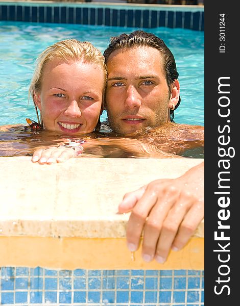 Attractive young couple relaxing by the pool. Attractive young couple relaxing by the pool