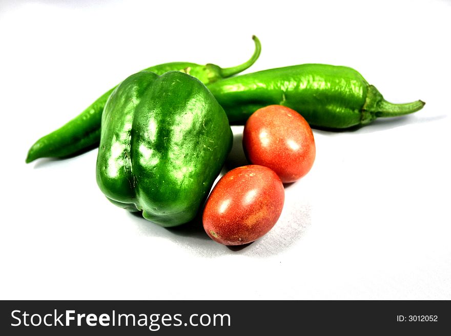 Green bell pepper, tomatoes and hot peppers to make salsa. Green bell pepper, tomatoes and hot peppers to make salsa