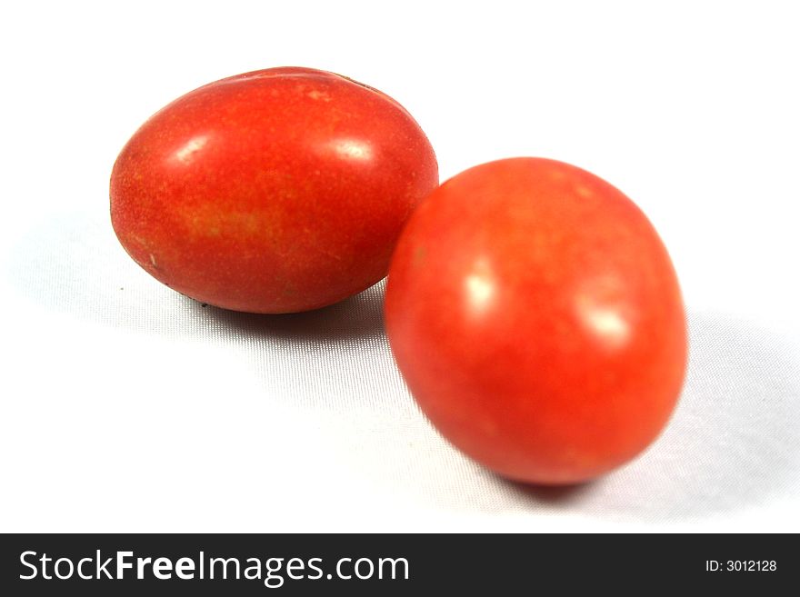 Two macro tomatoes bright red and juicy looking