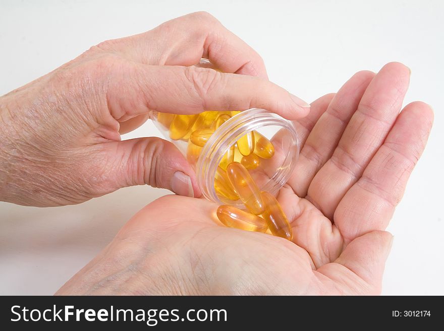 Close-up on pills being poured in a hand. Close-up on pills being poured in a hand