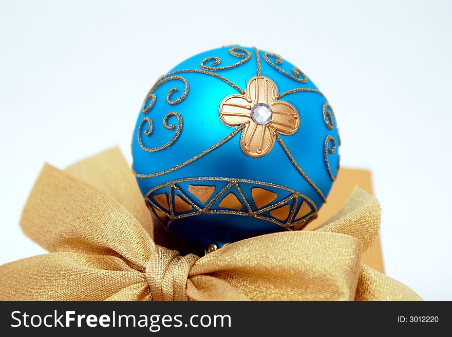 Isolated Christmas  gold and blue ball and golden bow. Isolated Christmas  gold and blue ball and golden bow