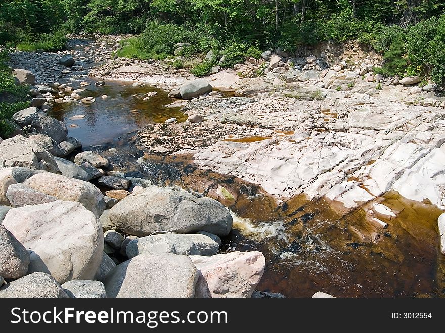 Crystal clear river flowing over the rocky landscape of Cape Breton, Nova Scotia, Canada. Crystal clear river flowing over the rocky landscape of Cape Breton, Nova Scotia, Canada.