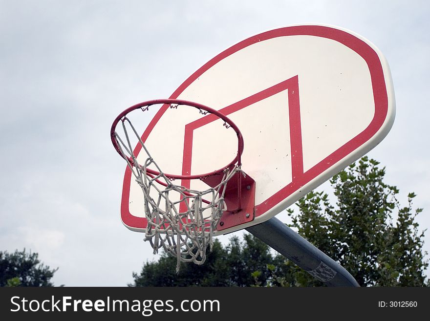 A closeup of a worn-out basketball hoop.