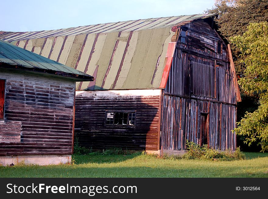 An old abandoned warehouse lit by the setting sun.