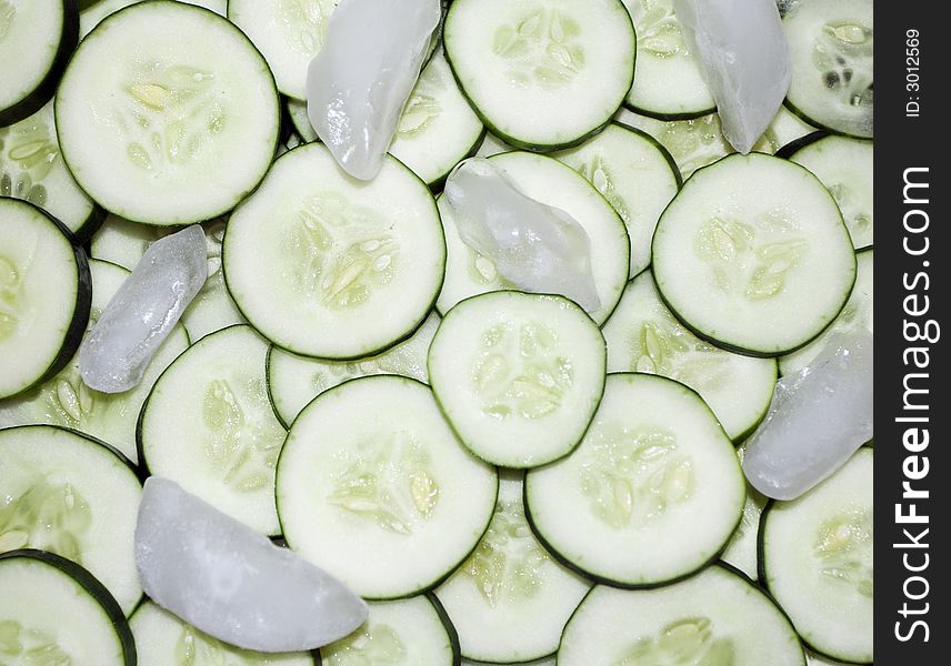 Fresh, cool cucumbers! Pile of freshly sliced cucumbers, tossed with ice cubs.