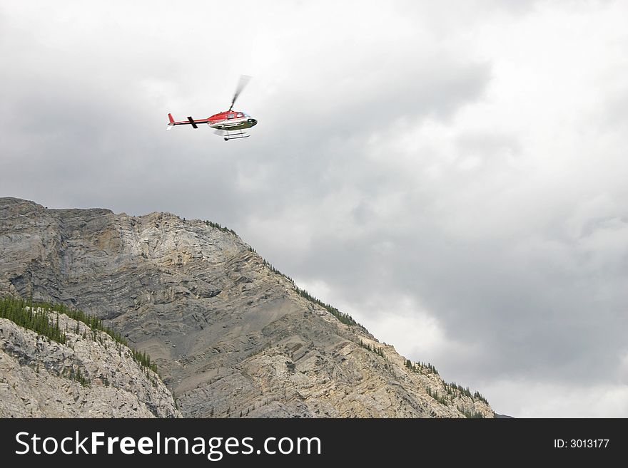 Helicopter flying over the mountains with overcast sky. Helicopter flying over the mountains with overcast sky.