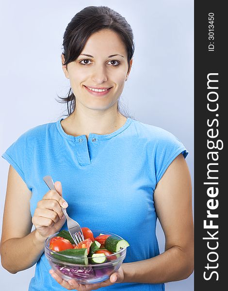 Beautiful young girl holding plate with salad. Beautiful young girl holding plate with salad