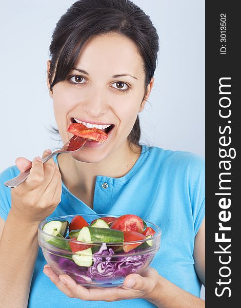 Beautiful young girl holding plate with salad. Beautiful young girl holding plate with salad