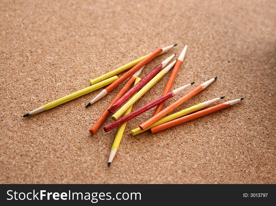 Miniature pencils on a cork background. Miniature pencils on a cork background