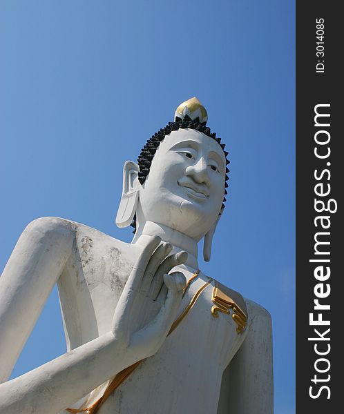 Buddhist statue from Thailand against a blue sky - travel and tourism.