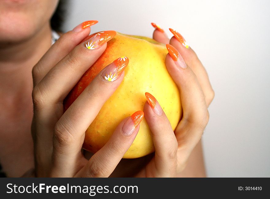 The woman holds an apple in hands. The woman holds an apple in hands