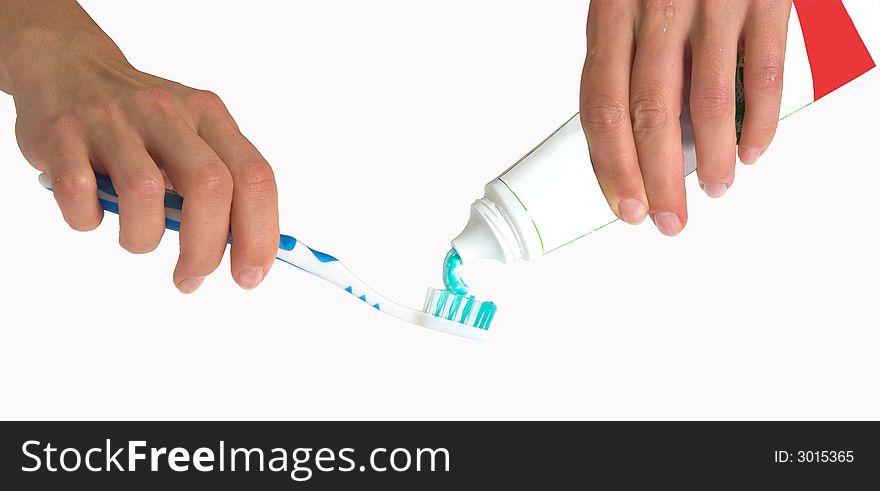 Girl squeezing toothpaste on a toothbrush