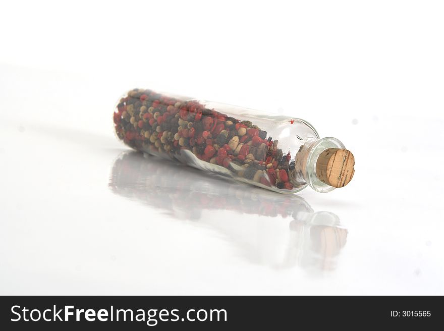 Jar with pepper isolated on white