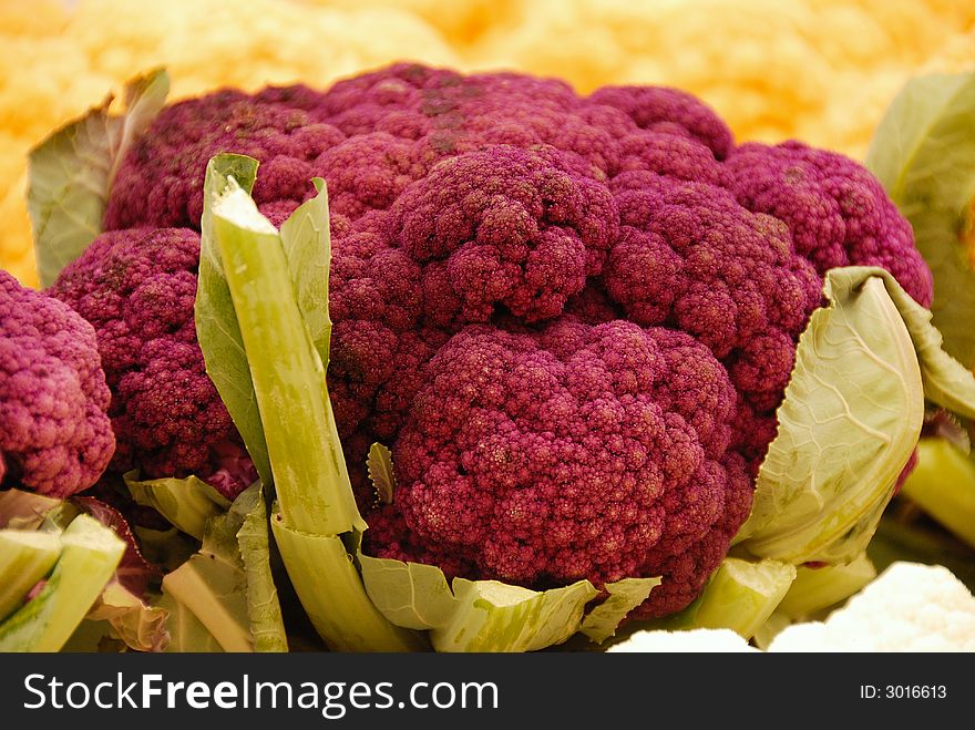 A display of purple and yellow broccoli at an outdoor market in Ottawa, Canada. A display of purple and yellow broccoli at an outdoor market in Ottawa, Canada
