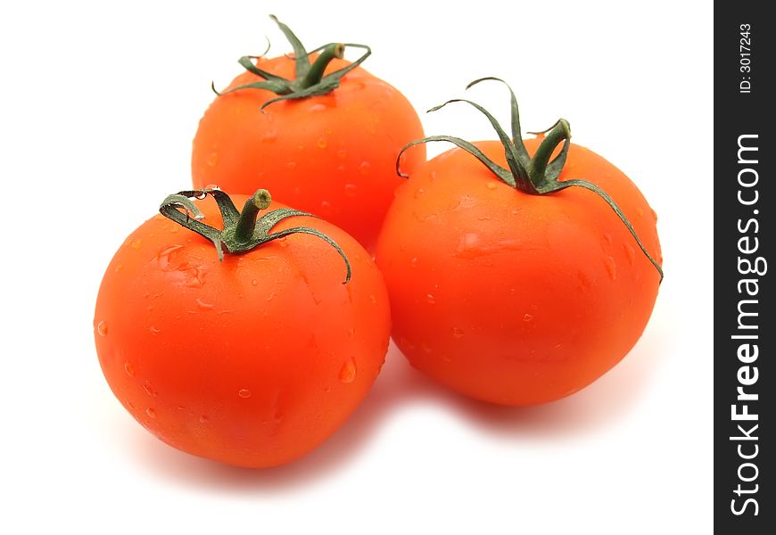 Three sweet tomatos. isolated on white. focus on first only.