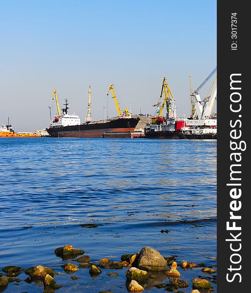 The trading ships in port. Picturesque coast of ocean