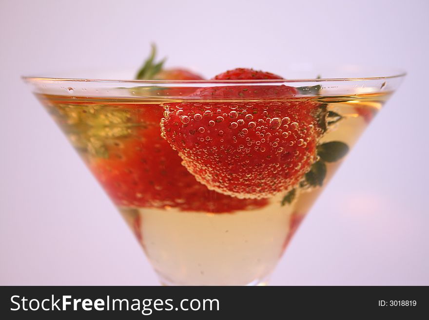 Strawberries in a glass of sparkling apple juice. Strawberries in a glass of sparkling apple juice