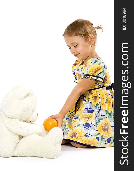 Little girl with orange and bear toy. Isolate on white background.