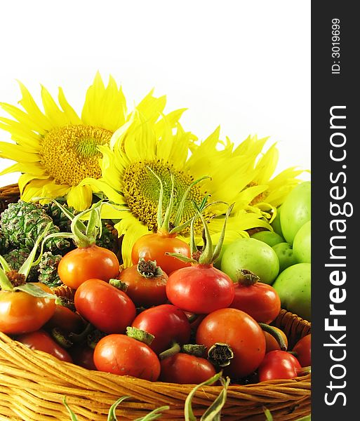 Nature, seasonal composition: fruits in basket summer on white background (sunflowers, roses, apples, cones)