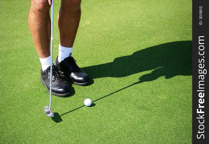 Closeup of man putting on golf course. Closeup of man putting on golf course