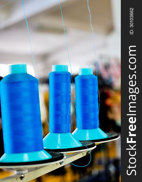 Blue spools in a clothing factory