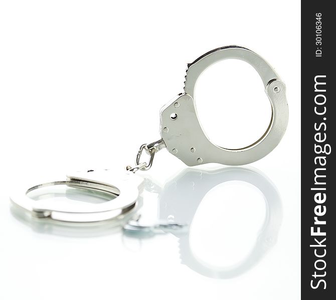 Handcuffs with shadow on a white background