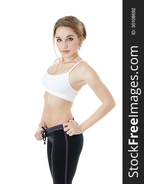 Beautiful athletic girl in white - black sportive clothes covering white background.Healthy lifestyle concept. Beautiful athletic girl in white - black sportive clothes covering white background.Healthy lifestyle concept.
