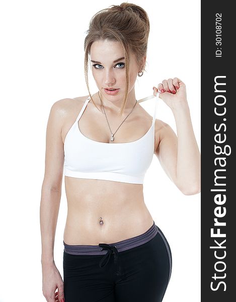 Seductive athletic girl in white - black sportive clothes covering white background.Healthy lifestyle concept. Seductive athletic girl in white - black sportive clothes covering white background.Healthy lifestyle concept.