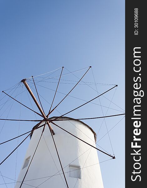 Traditional windmill of Santorini and blue sky.