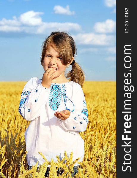 Small rural girl on wheat field