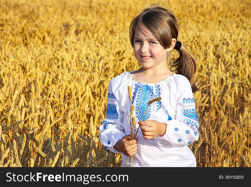 Small rural girl on wheat field