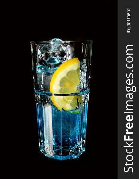 A blue drink in tall glass