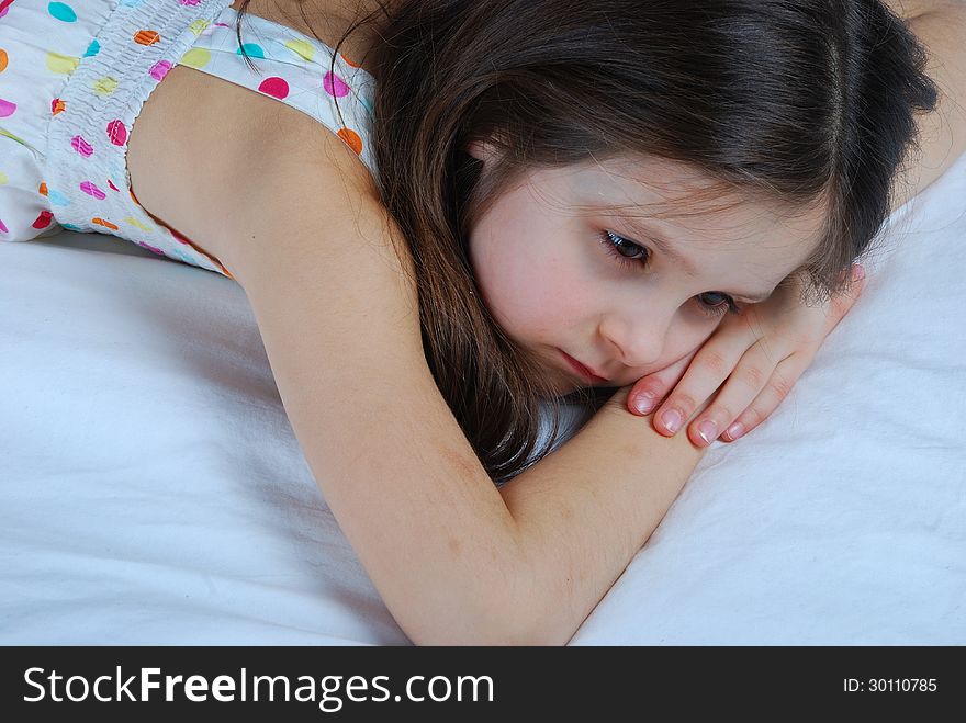 Young child, lying awake in his bed. This image has attached release.