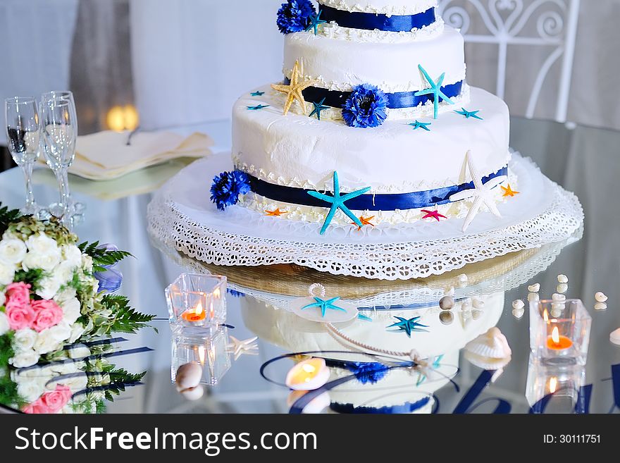 Eatiful decorated wedding cake with bride's bouquet and stemware. Eatiful decorated wedding cake with bride's bouquet and stemware