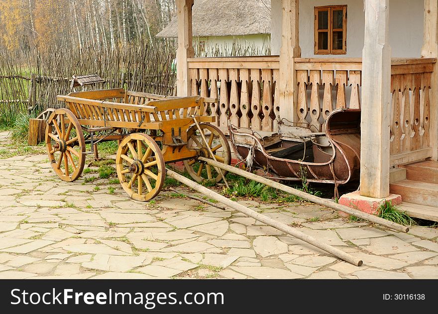 Cart and aged sledge about a porch