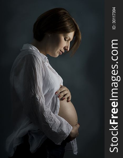 Pregnant woman holding her big belly. Pregnant woman holding her big belly