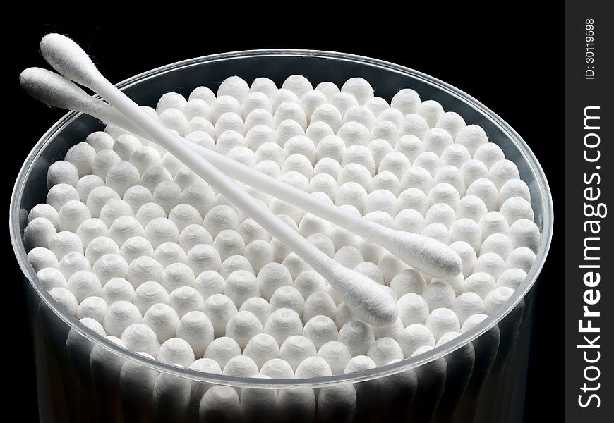 Plastic packing cotton buds on a black background.