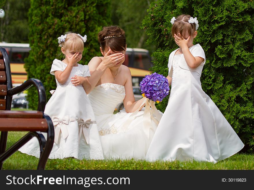 Bride stand with little girls in elegant dresses. Bride stand with little girls in elegant dresses