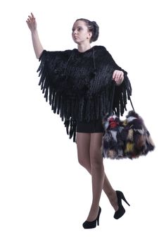 Fashionable Woman Walking In Black Poncho With Colorful Fur Bag And High-heel Shoes Stock Photos Fashionable Woman Walking In Black Poncho With Colorful Fur Bag And High-heel Shoes Stock Photos