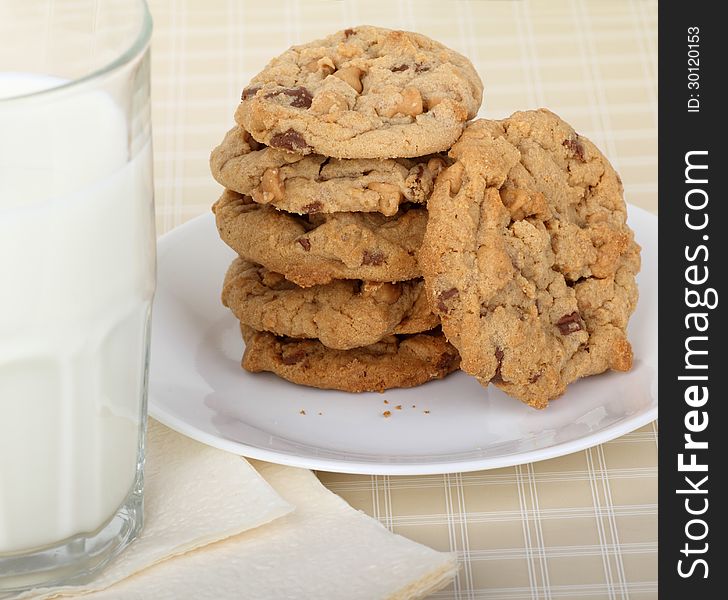 Peanut butter cookies stacked on a plate with glass of milk. Peanut butter cookies stacked on a plate with glass of milk