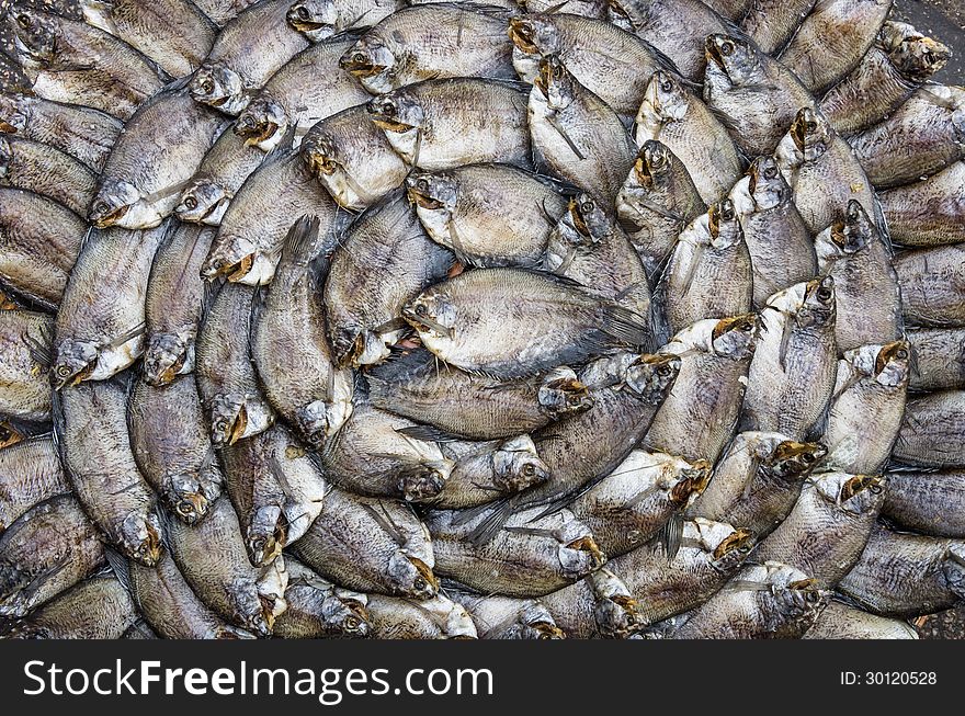 Spiral of dry fishes at a street food market in Saigon, Vietnam. Spiral of dry fishes at a street food market in Saigon, Vietnam.