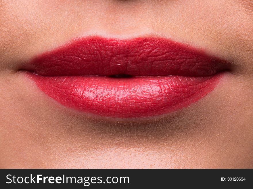 A high resolution image of Female lips with red lipstick